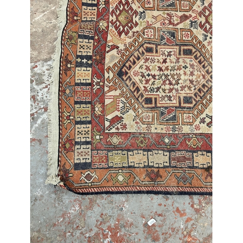 242 - An antique hand knotted rug - approx. 196cm x 118cm wide