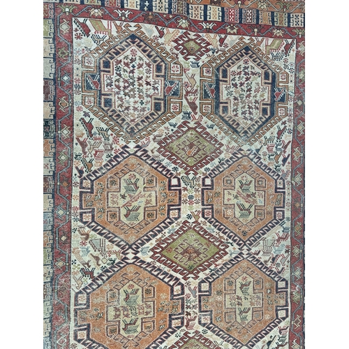 242 - An antique hand knotted rug - approx. 196cm x 118cm wide