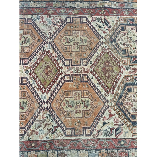 242 - An antique hand knotted rug - approx. 196cm x 118cm wide