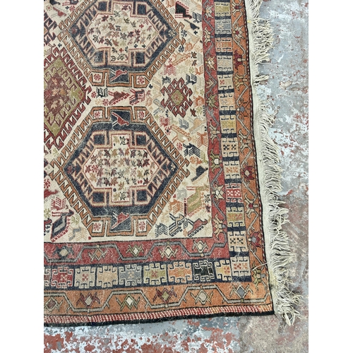 242 - An antique hand knotted rug - approx. 196cm x 118cm wide