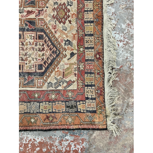 242 - An antique hand knotted rug - approx. 196cm x 118cm wide