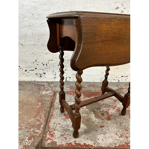 246 - An early 20th century oak serpentine drop leaf occasional table on barley twist supports - approx. 7... 