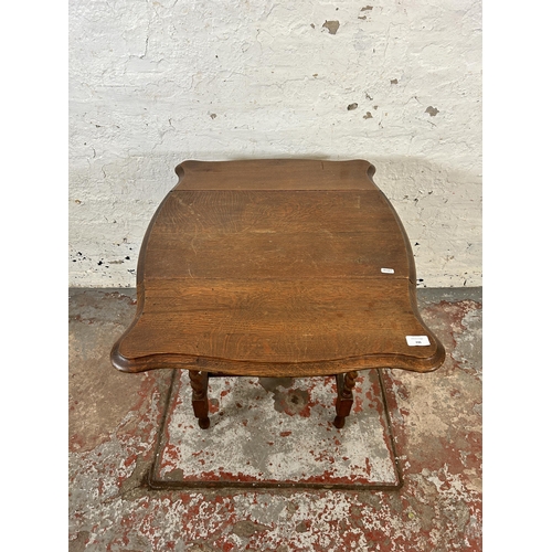 246 - An early 20th century oak serpentine drop leaf occasional table on barley twist supports - approx. 7... 