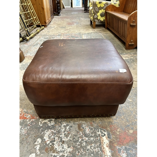26 - A modern brown leatherette and metal studded footstool - approx. 60cm x 60cm