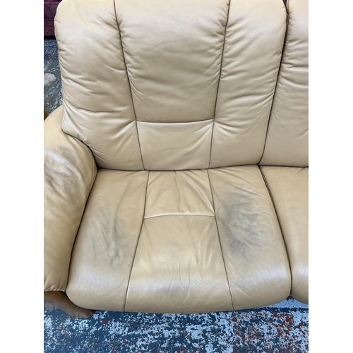 260 - An Ekornes Stressless tan leather and beech reclining two seater sofa - approx. 88cm high x 164cm wi... 