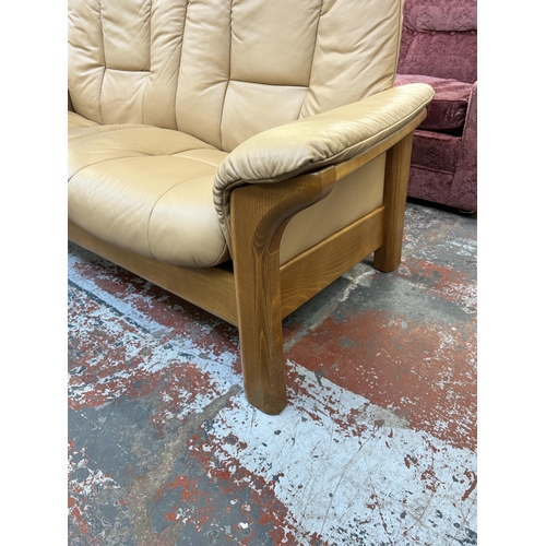 260 - An Ekornes Stressless tan leather and beech reclining two seater sofa - approx. 88cm high x 164cm wi... 