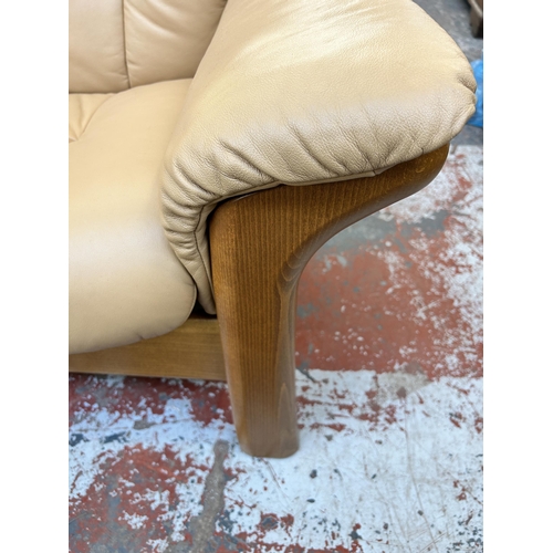 260 - An Ekornes Stressless tan leather and beech reclining two seater sofa - approx. 88cm high x 164cm wi... 