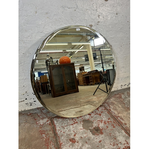 34 - A modern frameless bevelled edge wall mirror - approx. 103cm diameter