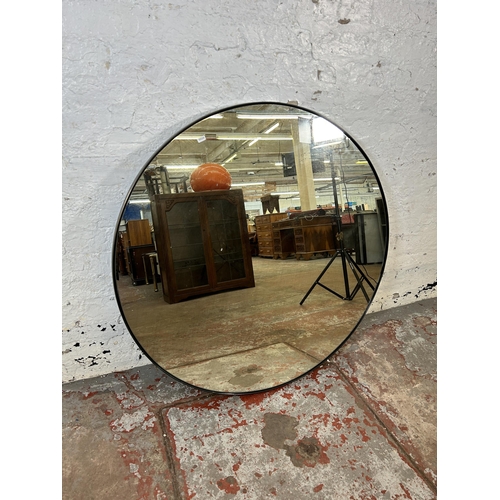 35 - A modern black metal framed circular wall mirror - approx. 100cm diameter