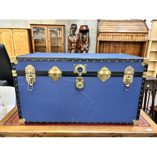 36 - A blue canvas travel trunk with brass fittings - approx. 52cm high x 92cm wide x 50cm deep