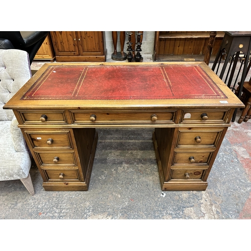 37 - A Victorian style pine and red leather pedestal writing desk - approx. 78cm high x 125cm wide x 65cm... 