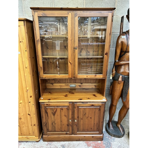 4 - A Ducal pine display cabinet - approx. 189cm high x 96cm wide x 44cm deep