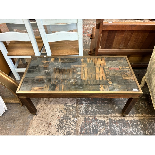 43 - A modern hardwood coffee table with ransom note style top - approx. 46cm high x 48cm wide x 104cm lo... 