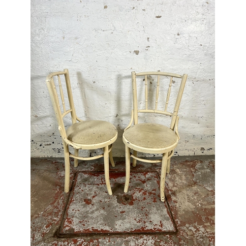 62 - A pair of mid 20th century white painted bentwood dining chairs