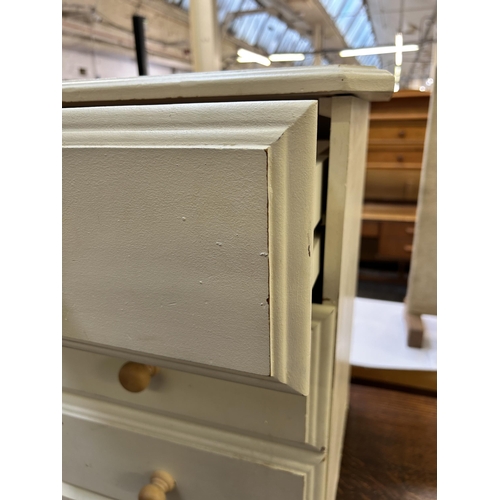 67 - A modern white painted pine bedside chest of drawers