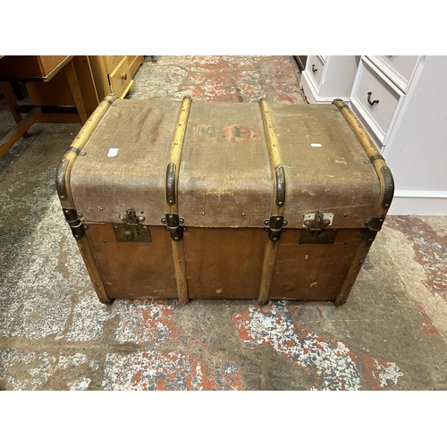74 - An early 20th century brown fibreboard and wooden banded travel trunk
