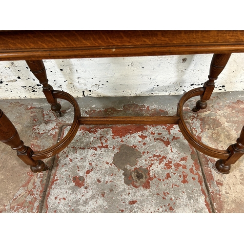 91 - A late 19th/early 20th century oak console table with lower H stretcher - approx. 75cm high x 106cm ... 