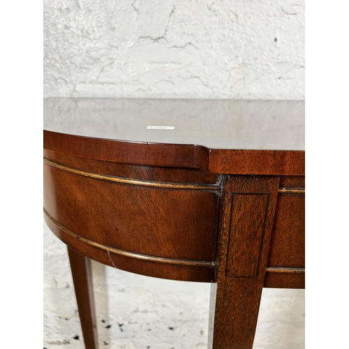 94 - A Bevan Funnell mahogany serpentine console table - approx. 82cm high x 122cm wide x 34cm deep