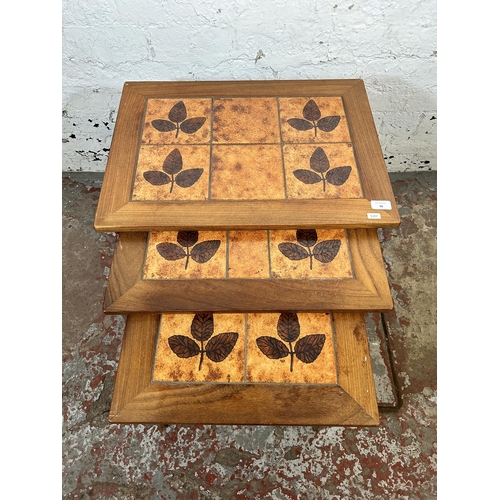 99 - A mid 20th century Keith Eatwell teak and tile top nest of tables - approx. 48cm high x 58cm wide x ... 