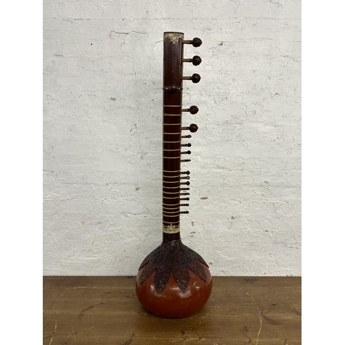 803 - An ornately carved and decorated standard sitar