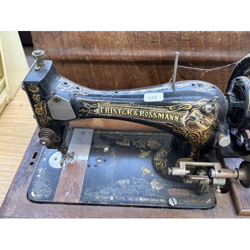 811 - A cased Frister & Rossmann hand crank sewing machine with accessories