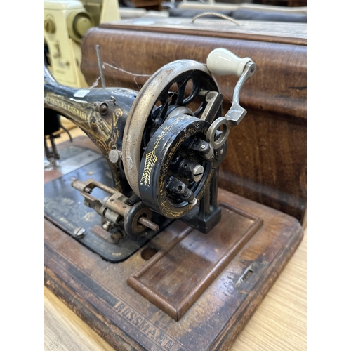 811 - A cased Frister & Rossmann hand crank sewing machine with accessories