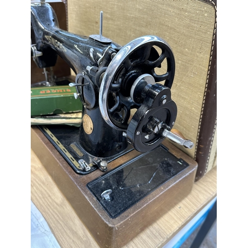 813 - A cased 1948 Singer 201K hand crank sewing machine with boxed attachments and instruction manual