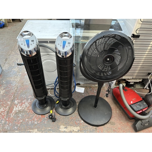 838 - Three floor standing fans, two Honeywell Quiet Set tower and one black plastic