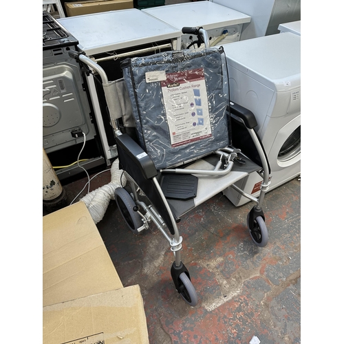 844 - A Drive folding wheelchair with brakes, footrests, tool kit, instruction manual and packaged cushion