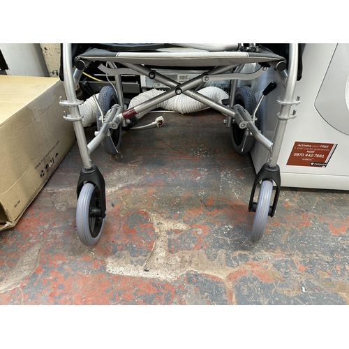 844 - A Drive folding wheelchair with brakes, footrests, tool kit, instruction manual and packaged cushion