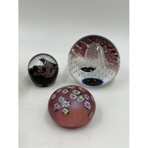 325 - Five art glass paperweights to include Welsh Royal Crystal, Caithness Scotland Millennium 2000, Isle... 