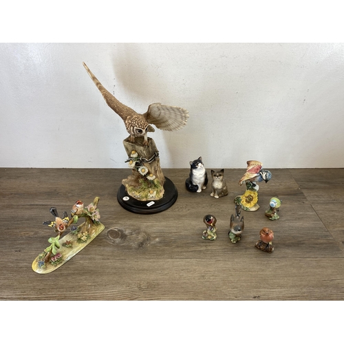 374 - Nine animal figurines, one Teviotdale resin owl and eight ceramic to include Royal Doulton Cat HN999... 