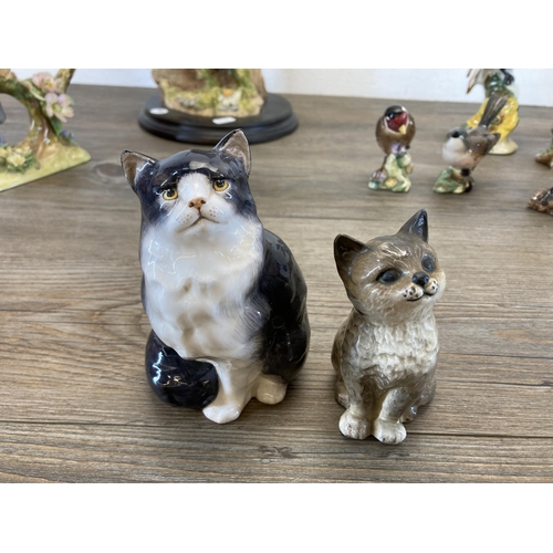 374 - Nine animal figurines, one Teviotdale resin owl and eight ceramic to include Royal Doulton Cat HN999... 