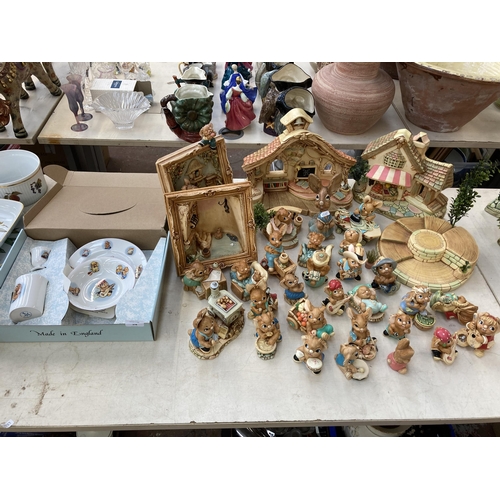 378 - A collection of Pendelfin rabbit figurines and display stands to include Old Schoolhouse, Fruit Shop... 