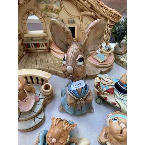 378 - A collection of Pendelfin rabbit figurines and display stands to include Old Schoolhouse, Fruit Shop... 