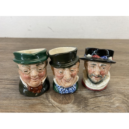 384 - Nine ceramic miniature character jugs, eight Royal Doulton and one Lancaster Sandland