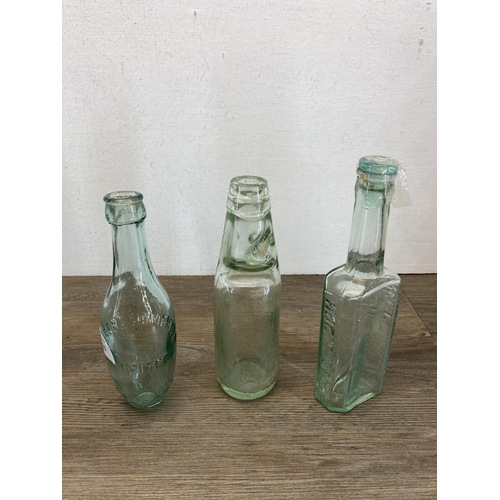 385 - Six antique glass bottles to include Smith's Swinton, Hoe's Sauce etc.