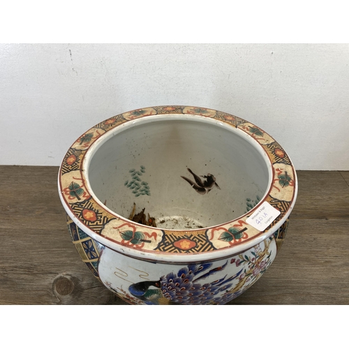 401A - An Oriental porcelain fish bowl jardinière - approx. 24cm high x 30cm diameter