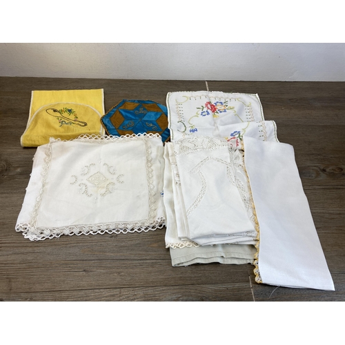 486 - A collection of vintage table linen to include embroidered lace etc.