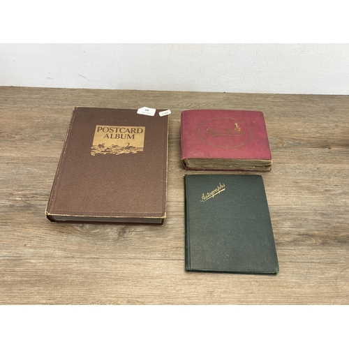 495 - Two albums containing a collection of antique and later postcards to include military, The Royal Fam... 