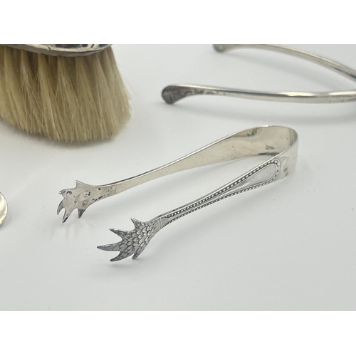 2291 - Five hallmarked sterling silver items, two spoons, two sugar tongs and one brush - approx. gross sil... 