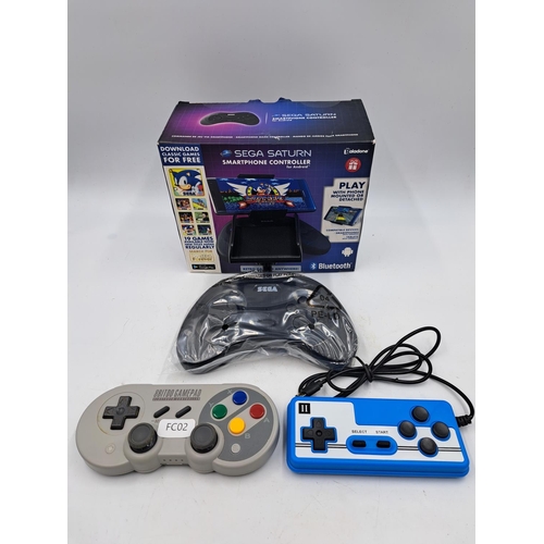 723 - Three items, one boxed Sega Saturn Bluetooth smartphone controller for Android devices, one 8Bitdo G... 