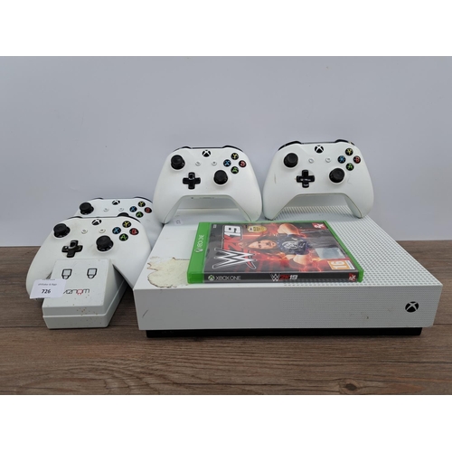 A white Microsoft Xbox One S All Digital Edition with four white Xbox ...