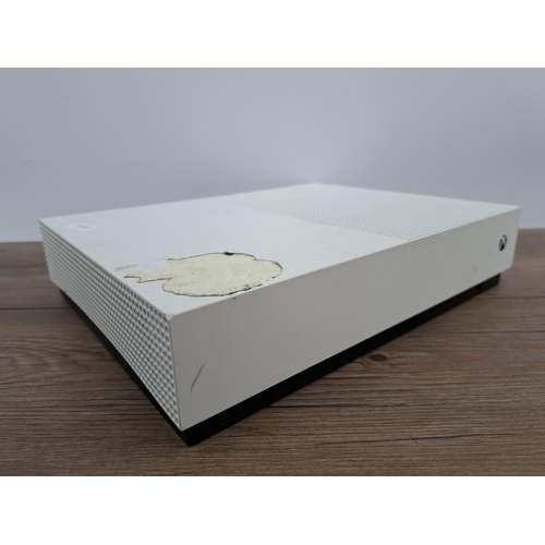 726 - A white Microsoft Xbox One S All Digital Edition with four white Xbox One controllers, WWE 2K19 game... 