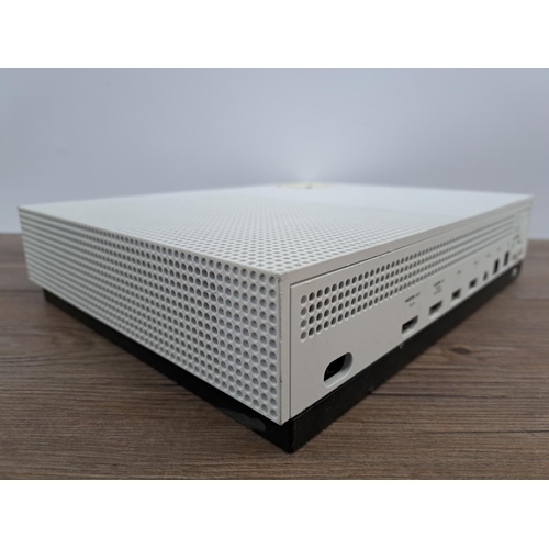 726 - A white Microsoft Xbox One S All Digital Edition with four white Xbox One controllers, WWE 2K19 game... 