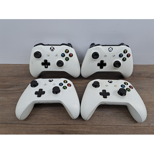 726 - A white Microsoft Xbox One S All Digital Edition with four white Xbox One controllers, WWE 2K19 game... 