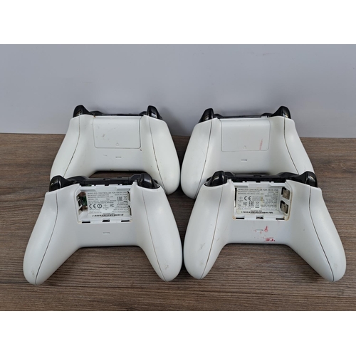 726 - A white Microsoft Xbox One S All Digital Edition with four white Xbox One controllers, WWE 2K19 game... 