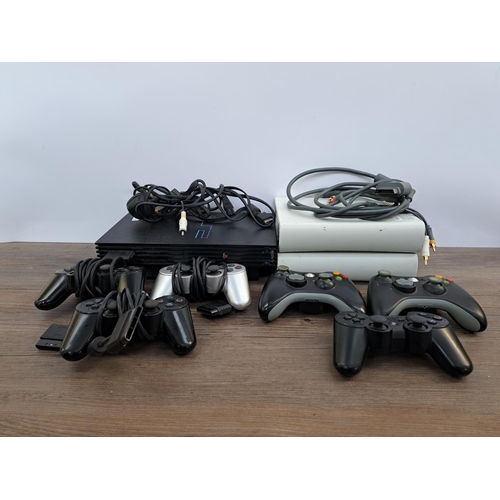 732 - A box containing Sony PlayStation 2 console with three controllers and cables, two Microsoft Xbox 36... 