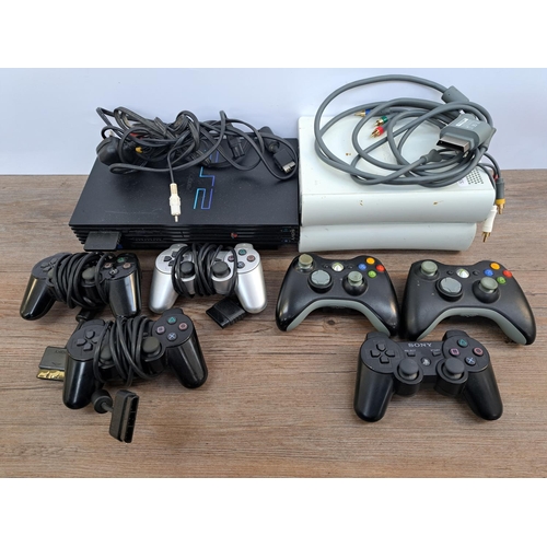 732 - A box containing Sony PlayStation 2 console with three controllers and cables, two Microsoft Xbox 36... 