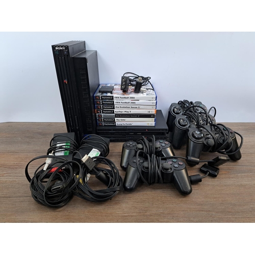 733 - Three Sony PlayStation 2 consoles, two slim and one original with cables, four controllers, one offi... 